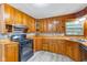 Classic kitchen featuring wooden countertops and cabinets, gas range, and tile backsplash at 3841 S Sherman Dr, Indianapolis, IN 46237