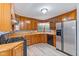 Charming kitchen features wood cabinets, stainless steel refrigerator, and gas range at 3841 S Sherman Dr, Indianapolis, IN 46237
