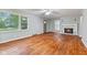 Bright living room with hardwood floors, fireplace, and ample natural light through a large window at 3841 S Sherman Dr, Indianapolis, IN 46237
