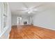 Living room featuring gleaming hardwood floors, neutral walls, ceiling fan and fireplace at 3841 S Sherman Dr, Indianapolis, IN 46237