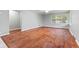 Spacious living room with gleaming hardwood floors and a large window allowing for natural light at 3841 S Sherman Dr, Indianapolis, IN 46237