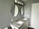 Bathroom features a double sink vanity with contemporary lighting and mirrors at 4004 N Ball Ave, Muncie, IN 47304