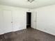 Bedroom with carpet, neutral paint, a closet, and an open doorway to another room at 4004 N Ball Ave, Muncie, IN 47304
