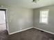 Bedroom with carpet, one window with blinds, neutral paint and a doorway to another room at 4004 N Ball Ave, Muncie, IN 47304