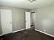 Bedroom with carpet, neutral paint, an open doorway to another room and two closets at 4004 N Ball Ave, Muncie, IN 47304