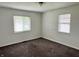 Bedroom with carpet, two windows with blinds, neutral paint and standard ceiling light at 4004 N Ball Ave, Muncie, IN 47304