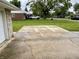 Spacious driveway leading to a single-Gathering home with a white Jeep parked in the distance at 4004 N Ball Ave, Muncie, IN 47304