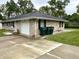 Spacious driveway leads to an attached garage and a well-maintained lawn at 4004 N Ball Ave, Muncie, IN 47304