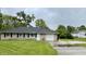 Charming one-story home with a well-maintained lawn, stone exterior, and attached garage at 4004 N Ball Ave, Muncie, IN 47304
