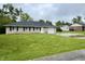 Charming one-story home with a well-maintained lawn, stone exterior, and attached garage at 4004 N Ball Ave, Muncie, IN 47304
