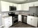 Updated kitchen featuring stainless steel appliances and white cabinets at 4004 N Ball Ave, Muncie, IN 47304