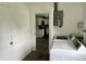 This laundry room has white walls, appliances, and a doorway into the kitchen at 4004 N Ball Ave, Muncie, IN 47304