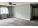 Living room featuring neutral paint, large window, ceiling fan, and carpet at 4004 N Ball Ave, Muncie, IN 47304