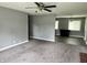 Bright living room with gray walls, plush carpet, and view of dining area at 4004 N Ball Ave, Muncie, IN 47304