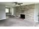 Living room with stone fireplace, gray walls, and gray carpet at 4004 N Ball Ave, Muncie, IN 47304