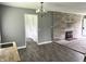Living room with stone fireplace, gray walls, and wood flooring at 4004 N Ball Ave, Muncie, IN 47304