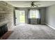 Inviting living room featuring gray walls, a brick fireplace, and a window offering natural light at 4004 N Ball Ave, Muncie, IN 47304