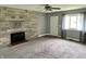 Bright living room with gray walls, plush carpet, and a stone fireplace feature at 4004 N Ball Ave, Muncie, IN 47304