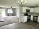 Open-concept living space with kitchen, dining area, and carpeted living room at 4004 N Ball Ave, Muncie, IN 47304