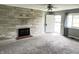 Open living room with a stone fireplace and a ceiling fan at 4004 N Ball Ave, Muncie, IN 47304