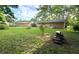 Grassy backyard with a firepit, surrounded by wood at 403 Us Highway 31 N, Greenwood, IN 46142