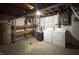 Unfinished basement featuring a washer, dryer, shelving, and other mechanical systems at 403 Us Highway 31 N, Greenwood, IN 46142