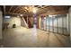 Unfinished basement featuring exposed framing, concrete floor, and stairs at 403 Us Highway 31 N, Greenwood, IN 46142