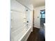Bathroom featuring a standard white tub and shower, with doorway view to bedroom at 403 Us Highway 31 N, Greenwood, IN 46142