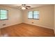 Bedroom featuring hardwood floors, two windows for natural light, and ceiling fan at 403 Us Highway 31 N, Greenwood, IN 46142