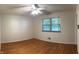Bright bedroom with a ceiling fan, hardwood floors, and natural light through the window at 403 Us Highway 31 N, Greenwood, IN 46142