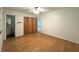 Large bedroom with hardwood floors, closet, and a doorway view into the bathroom at 403 Us Highway 31 N, Greenwood, IN 46142