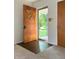 Bright foyer with a uniquely styled wooden front door and wood flooring at 403 Us Highway 31 N, Greenwood, IN 46142