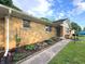 View of the home's exterior featuring brickwork, garden beds, and a well-kept sidewalk leading to the front door at 403 Us Highway 31 N, Greenwood, IN 46142