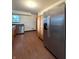 Eat-in kitchen featuring stainless steel appliances, wood cabinets, and hardwood-style flooring at 403 Us Highway 31 N, Greenwood, IN 46142