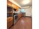 Traditional kitchen with wood cabinets, stainless steel appliances, and vinyl flooring at 403 Us Highway 31 N, Greenwood, IN 46142