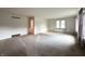 Large, carpeted living room with natural light, and neutral walls at 403 Us Highway 31 N, Greenwood, IN 46142