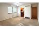 Living room featuring a ceiling fan and a view of the kitchen through an open doorway at 403 Us Highway 31 N, Greenwood, IN 46142