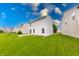 Spacious backyard with lush green grass and a view of neighboring houses at 4056 Orchard Valley Ln, Indianapolis, IN 46235