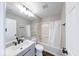 Bathroom featuring a shower-tub, modern sink vanity with black hardware and wood-look flooring at 4056 Orchard Valley Ln, Indianapolis, IN 46235