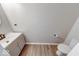 Powder room featuring wood-look flooring, modern sink vanity, and a toilet at 4056 Orchard Valley Ln, Indianapolis, IN 46235