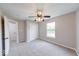 Neutral bedroom with a ceiling fan, carpet flooring and a view of the outside pond at 4056 Orchard Valley Ln, Indianapolis, IN 46235