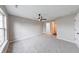 Primary bedroom featuring neutral carpet, a ceiling fan, and ensuite bathroom access at 4056 Orchard Valley Ln, Indianapolis, IN 46235