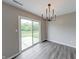 Dining area with modern light fixture and sliding glass door with a view of the backyard at 4056 Orchard Valley Ln, Indianapolis, IN 46235