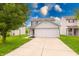 Traditional two-story home with a spacious driveway and well-maintained front lawn at 4056 Orchard Valley Ln, Indianapolis, IN 46235