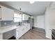 Well-lit kitchen with white cabinets, modern appliances, and granite countertops at 4056 Orchard Valley Ln, Indianapolis, IN 46235