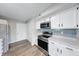 Kitchen showcasing white cabinetry, stainless steel appliances, and plenty of counter space at 4056 Orchard Valley Ln, Indianapolis, IN 46235