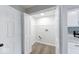 Laundry room with connections and lighting seen through folding closet doors at 4056 Orchard Valley Ln, Indianapolis, IN 46235