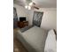 Cozy bedroom with a ceiling fan, side table, and large windows with patterned curtains at 4113 W 30Th St, Indianapolis, IN 46222