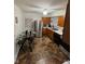 Cozy kitchen featuring stainless steel appliances, wooden cabinets, and a round glass dining table at 4113 W 30Th St, Indianapolis, IN 46222