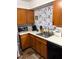 Well-lit kitchen featuring warm wood cabinets and stainless steel appliances at 4113 W 30Th St, Indianapolis, IN 46222